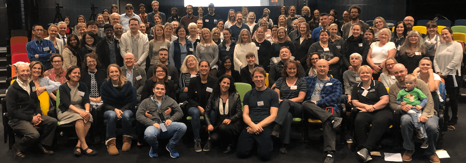 Group photo of GETA 2019 attendees seated in the auditorium