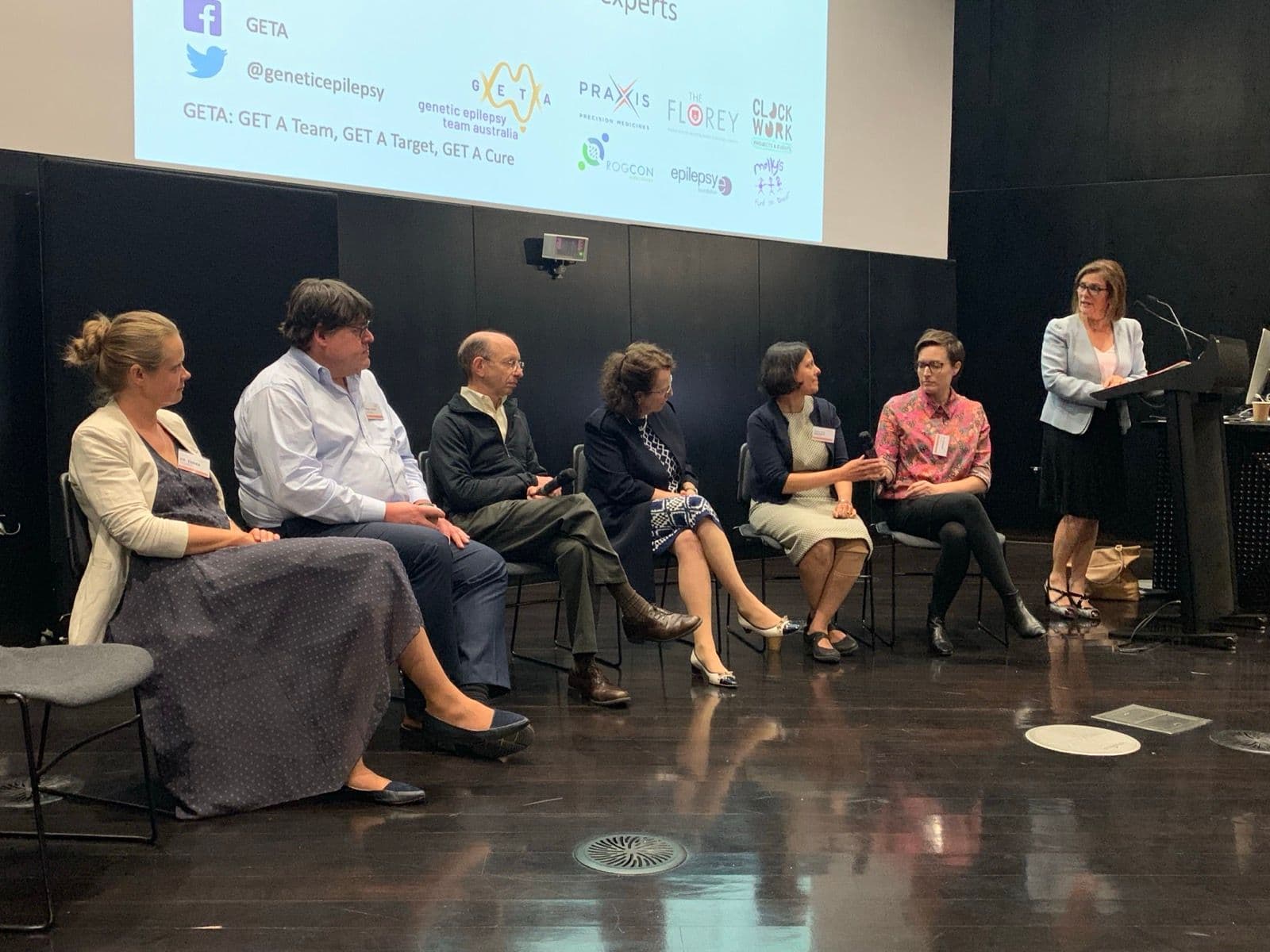 The panel of experts seated on stage