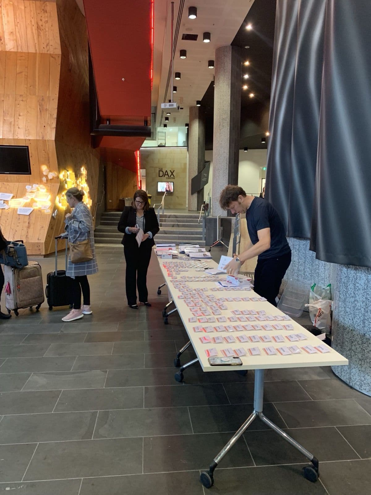 Registration desk with name badges laid out on a long table